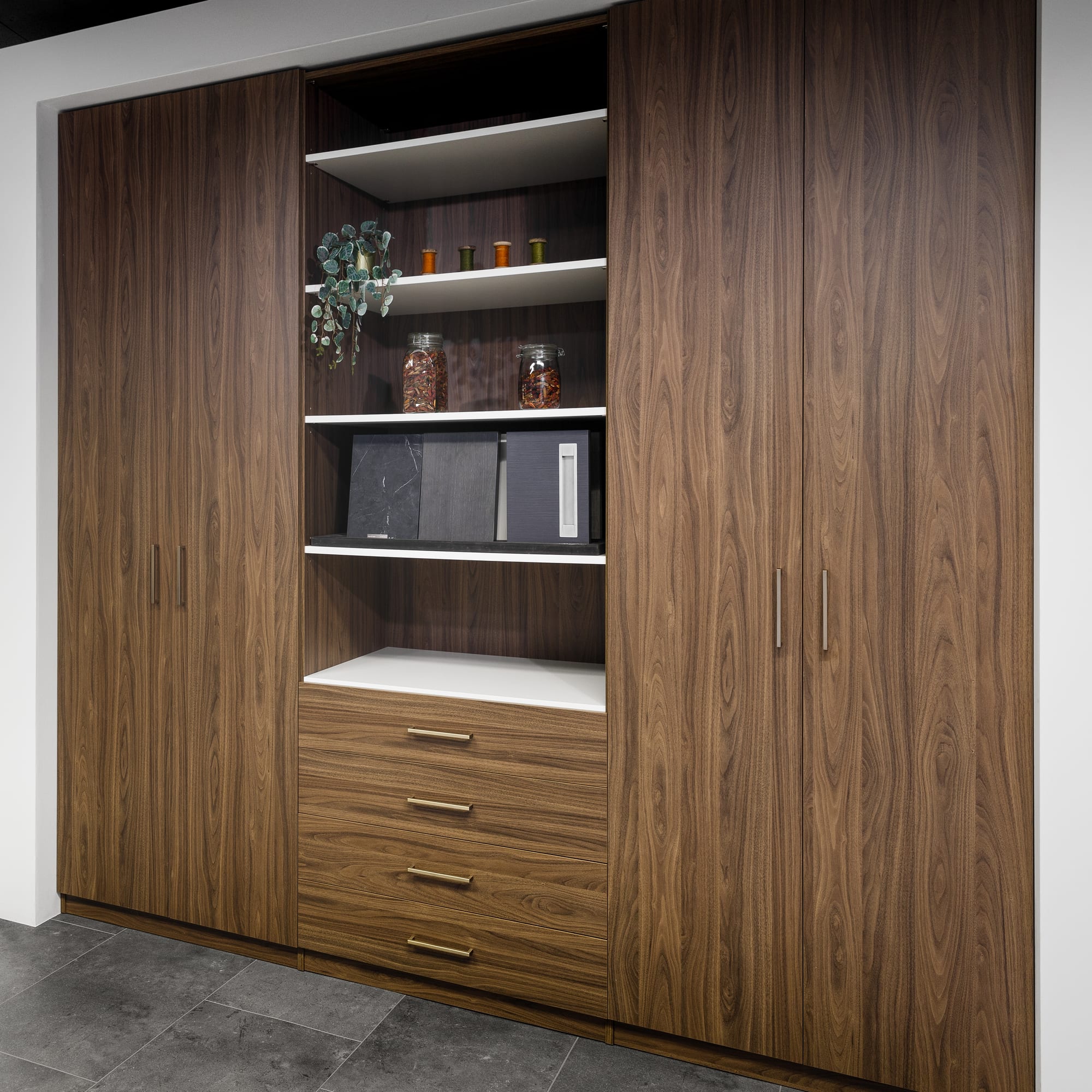 Kastenwand op maat in walnootdecor met open vakken en laden